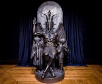 a statue of a demon in a room